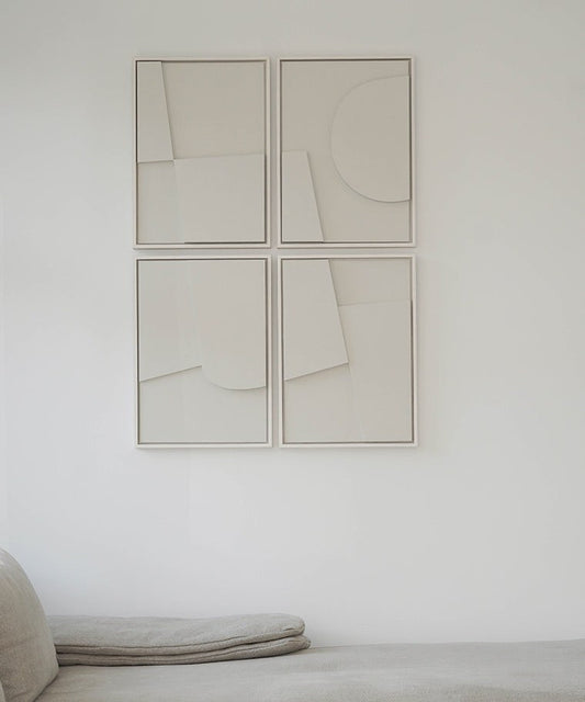 Handmade abstract art set of four panels with sand texture finish on a wall.