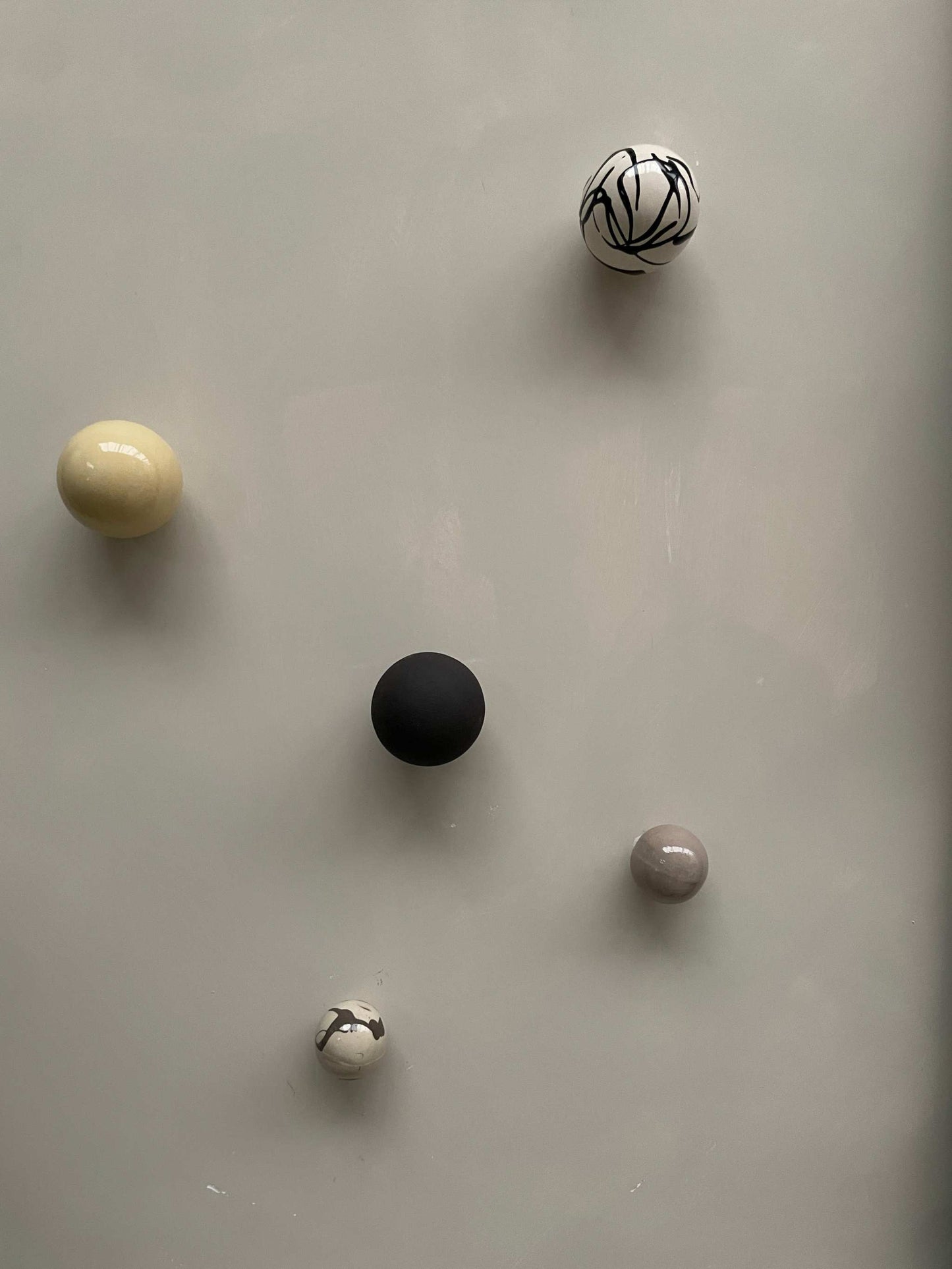 Handcrafted ceramic ball wall sculpture with artsy colors.