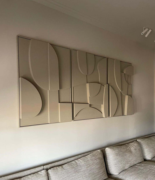 Handmade abstract wall art installation with sand texture and eco-paint, featuring a trio design in neutral tones.