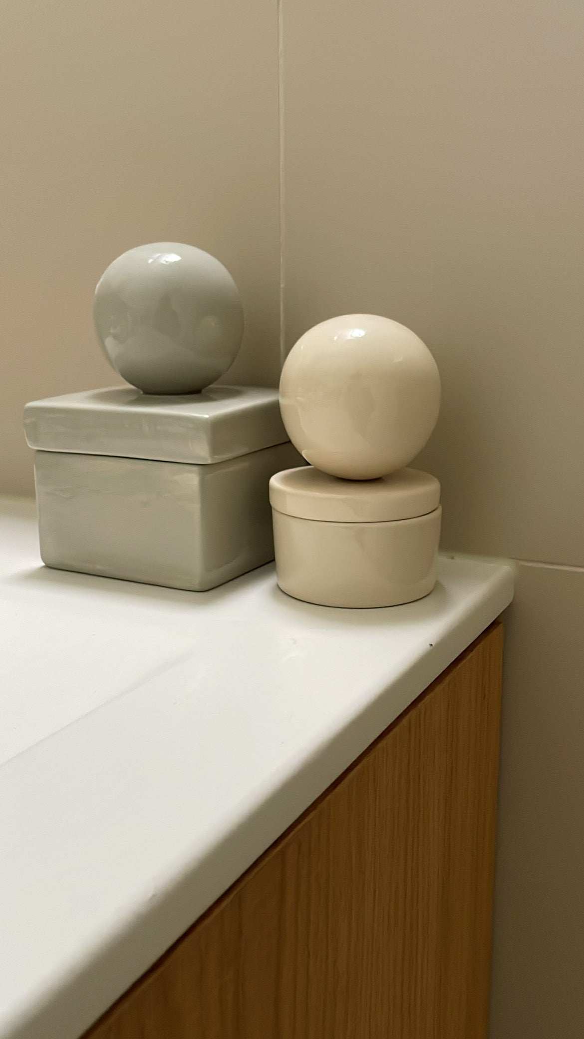 Small vanilla ceramic box 'BOULE' for keepsakes on a bathroom counter.