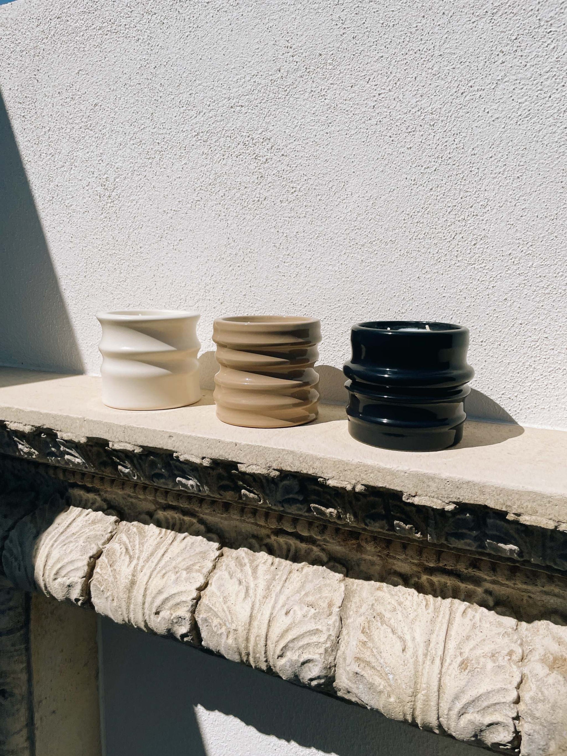 Scented candles in ceramic holders from the Shapes Collection, featuring unique designs by Edith Beurskens and handcrafted by Royal Goedewaagen.