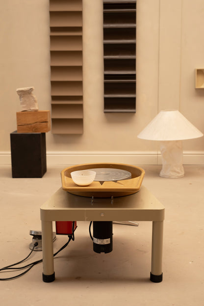 Private throwing wheel lesson setup in a cozy atelier.