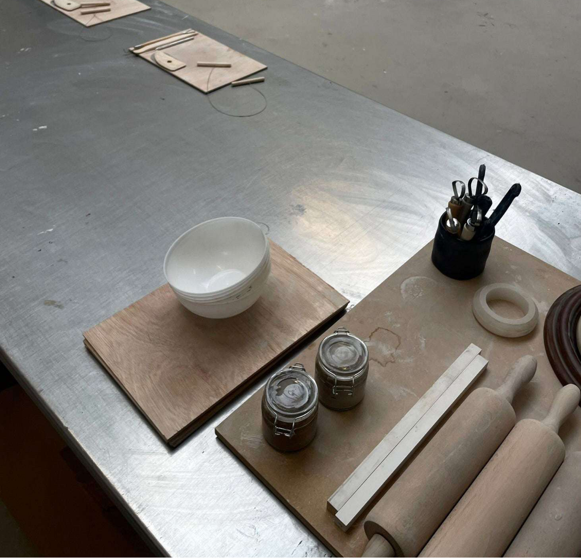 Handbuilding and glazing workshop setup with tools and materials for beginners.