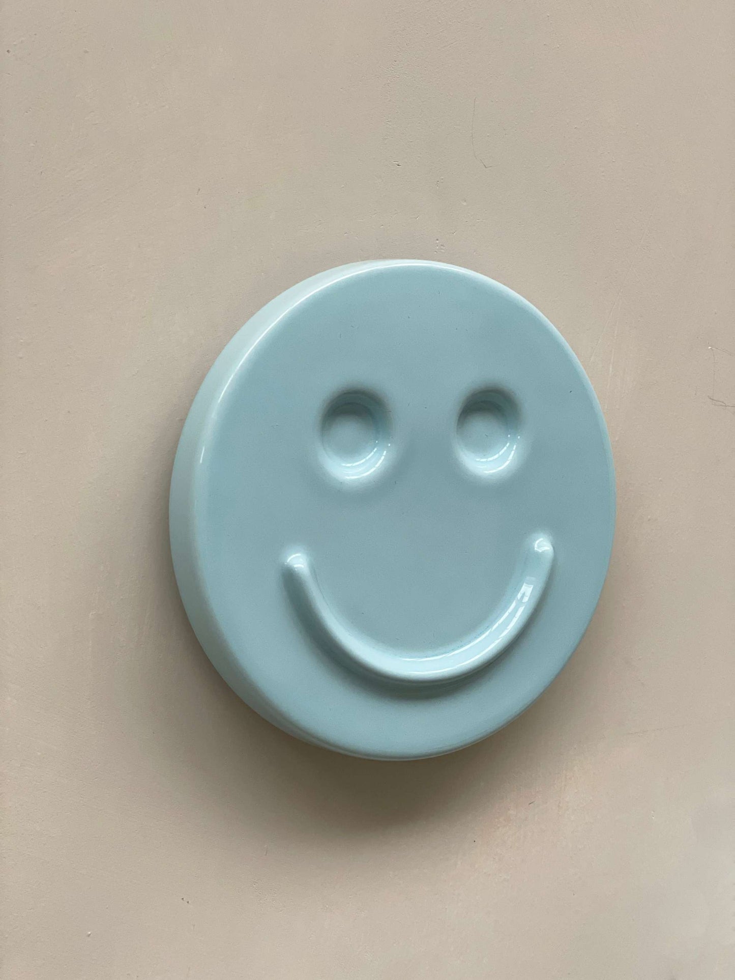 Sky Blue ceramic artwork with HAPPY face design