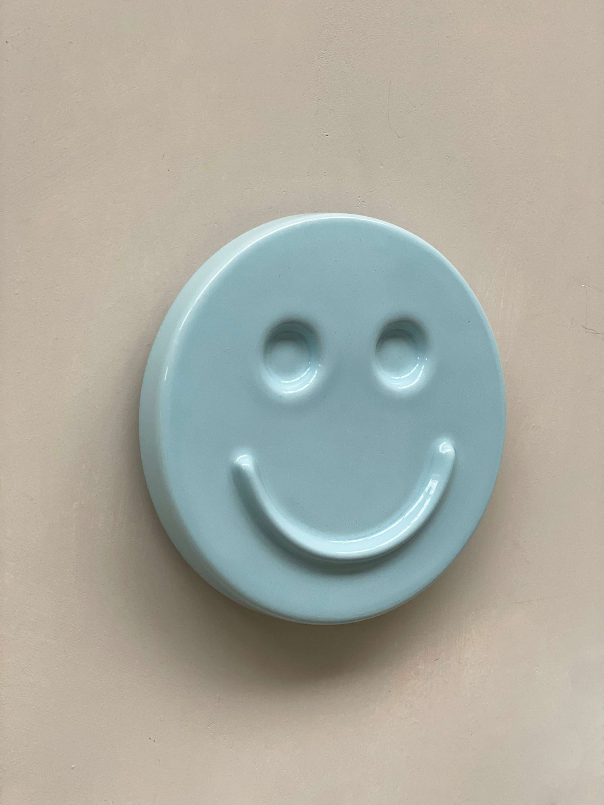 Sky Blue ceramic artwork with HAPPY face design