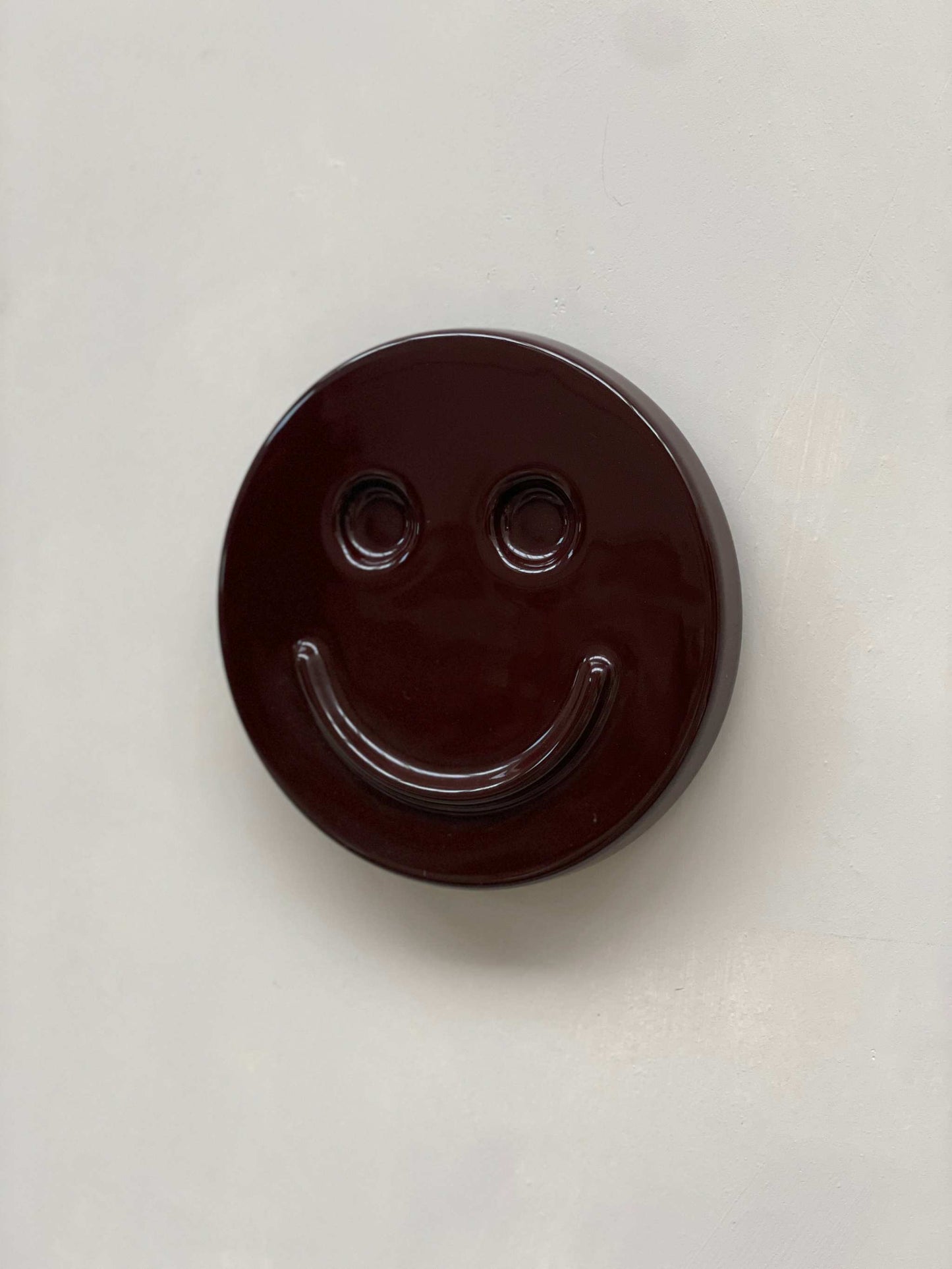 Eggplant SMILE ceramic artwork by Edith Beurskens, handcrafted and glazed.
