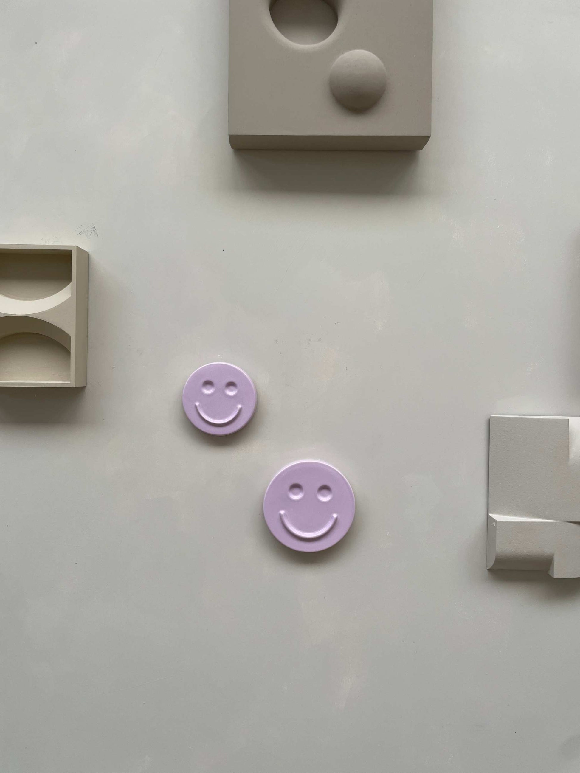 Orchid 'HAPPY' ceramic artwork on a neutral background with geometric shapes.