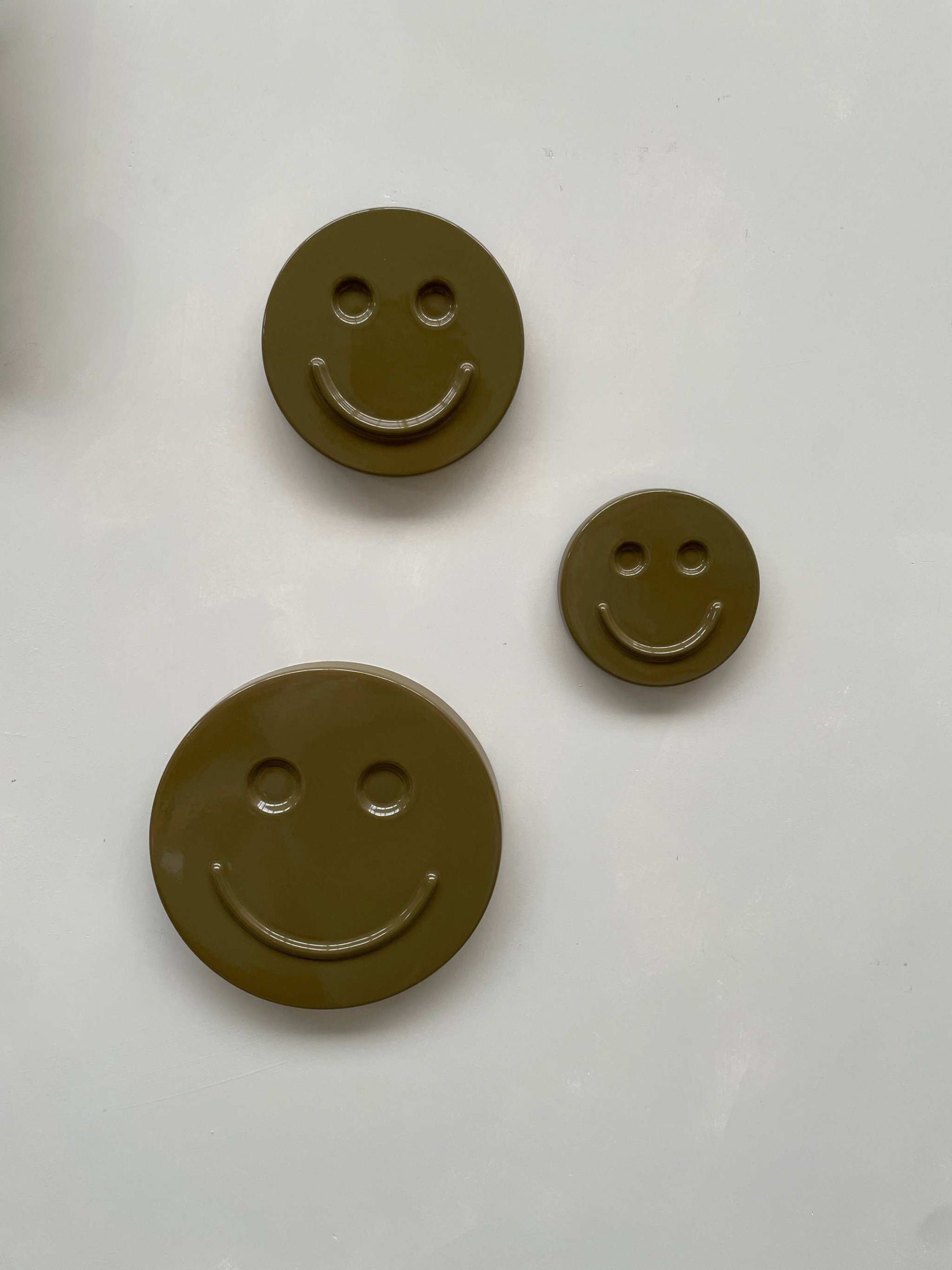 Olive 'HAPPY' ceramic artwork in various sizes, handcrafted and glazed.
