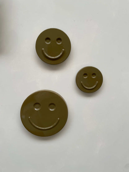 Olive 'HAPPY' ceramic artwork in various sizes, handcrafted and glazed.