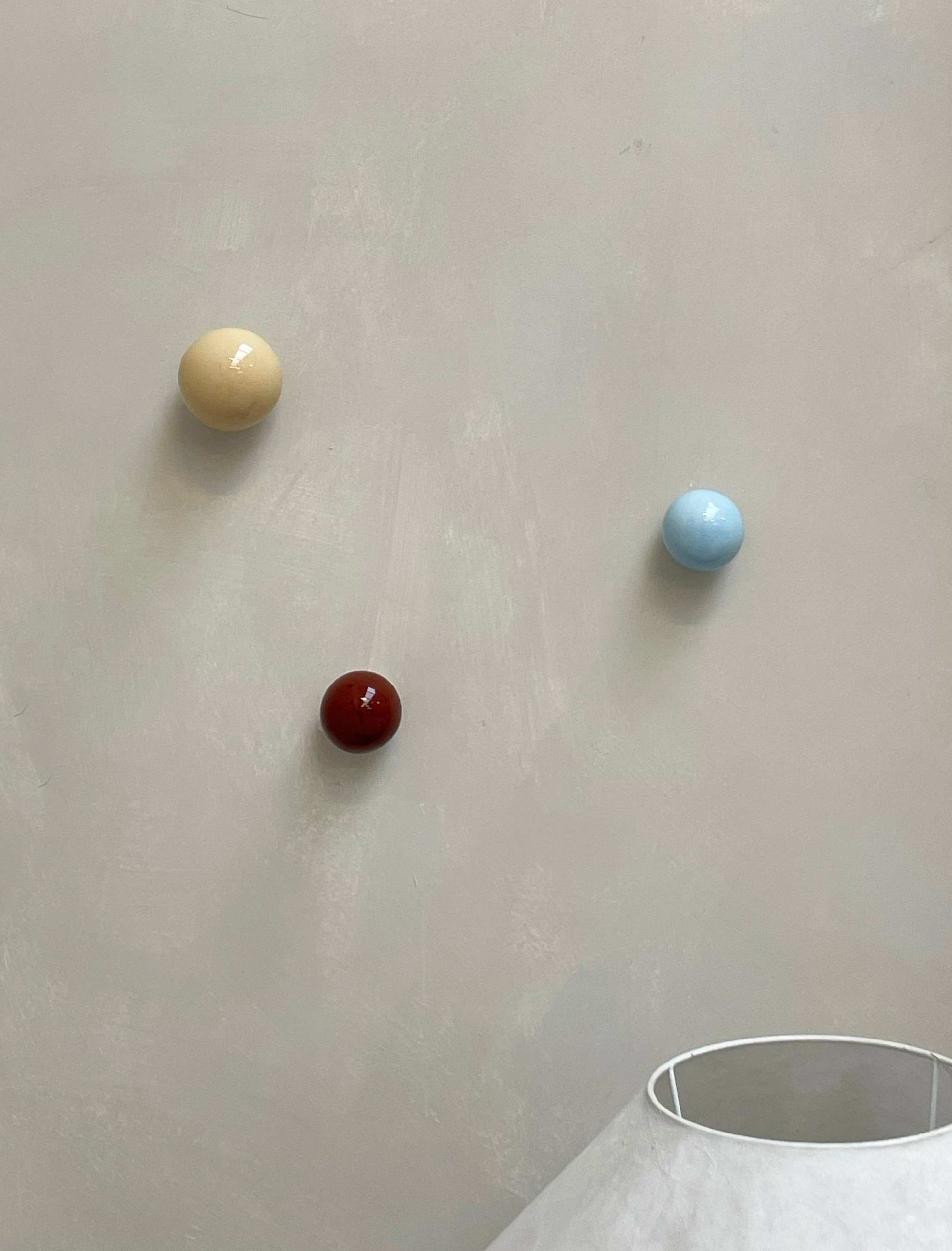 Set of 3 ceramic wall sculptures in butter, rust burgundy, and ice blue.