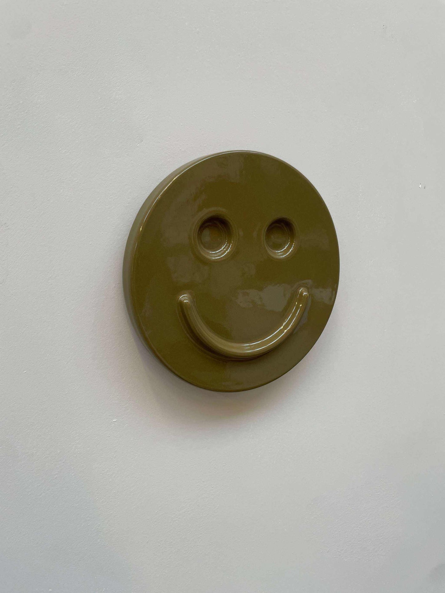 Olive 'HAPPY' ceramic artwork, handcrafted and glazed smiley face design.