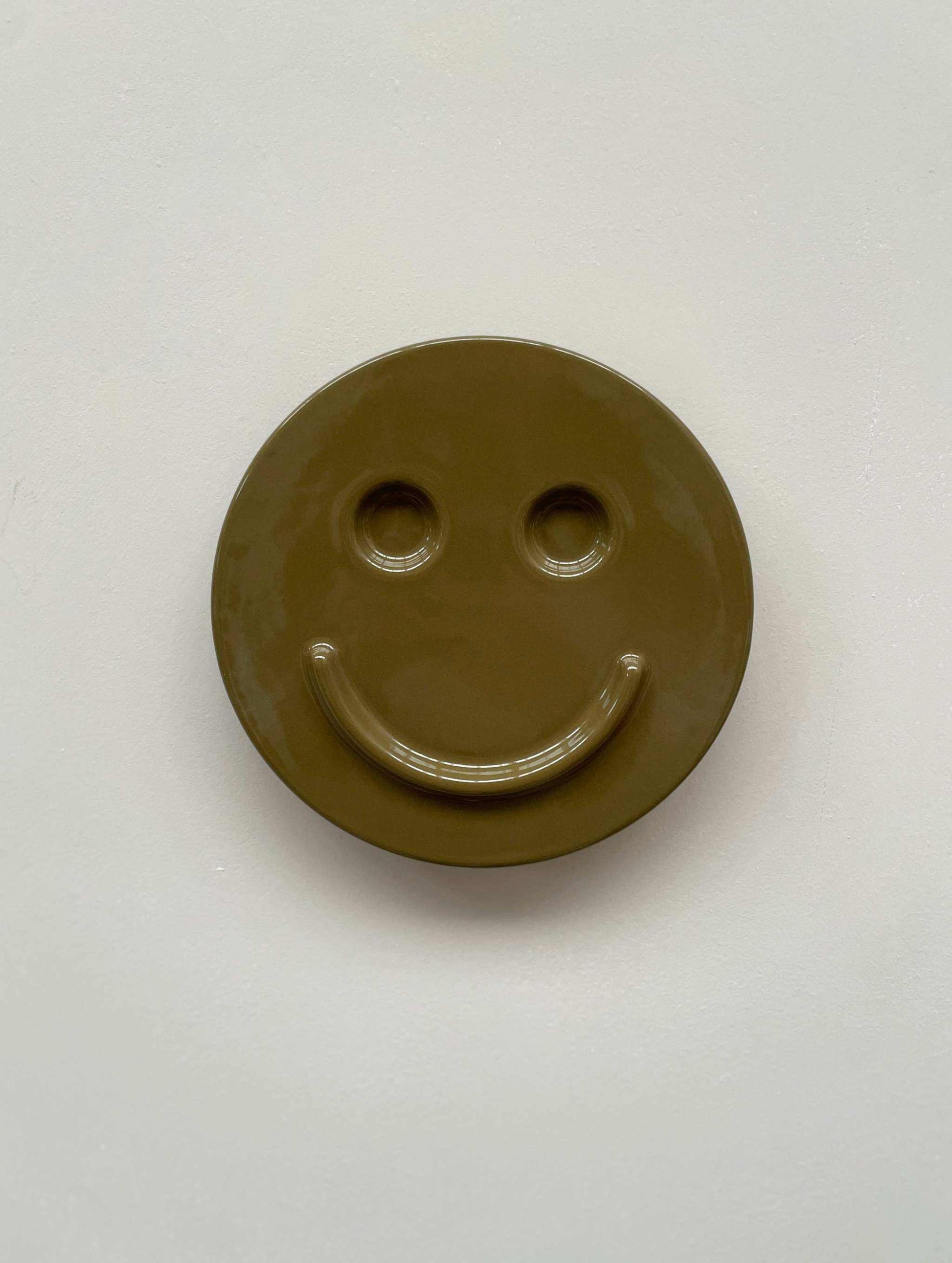 Olive 'HAPPY' ceramic artwork by Edith Beurskens, handcrafted smiley face design.
