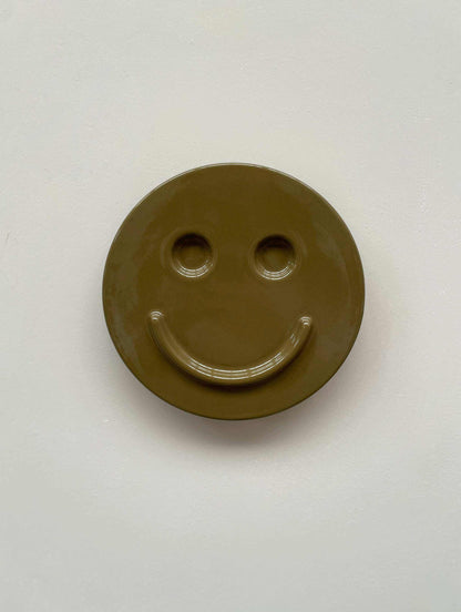 Olive 'HAPPY' ceramic artwork by Edith Beurskens, handcrafted smiley face design.