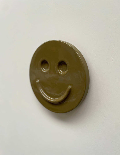 Olive 'HAPPY' ceramic artwork, handcrafted smiley face design.