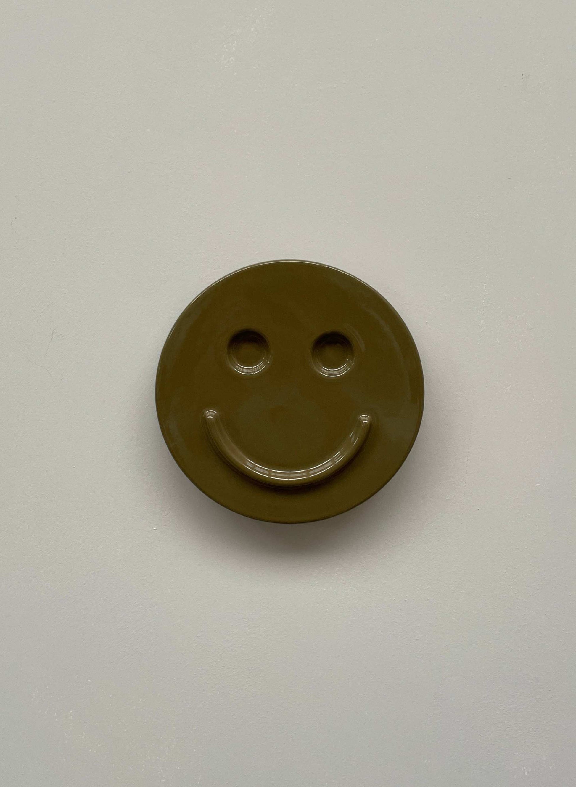 Olive 'HAPPY' ceramic artwork, handcrafted smiley face design.