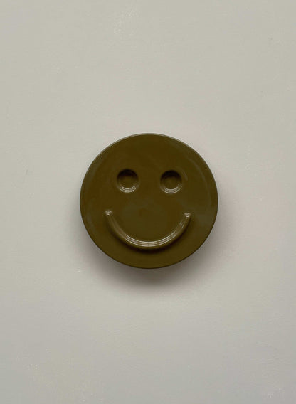 Olive 'HAPPY' ceramic artwork, handcrafted smiley face design.