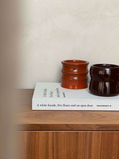 Shape 02.02 Aubergine ceramic candle holders by Royal Goedewaagen and Edith Beurskens, displayed on a wooden surface.