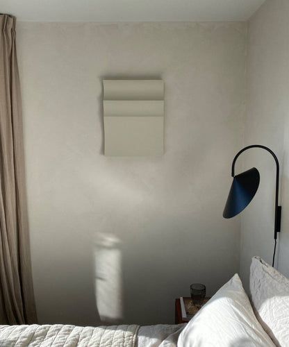 Handmade art piece "#22.01 Ark" on wall, crafted from biodegradable PLA with sand texture and eco-paint, in a minimalist bedroom setting.