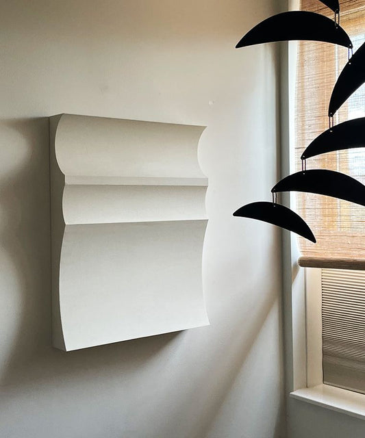 Hand-made wall art with sand texture finish, made from biodegradable PLA, featuring a minimalist design, displayed indoors.