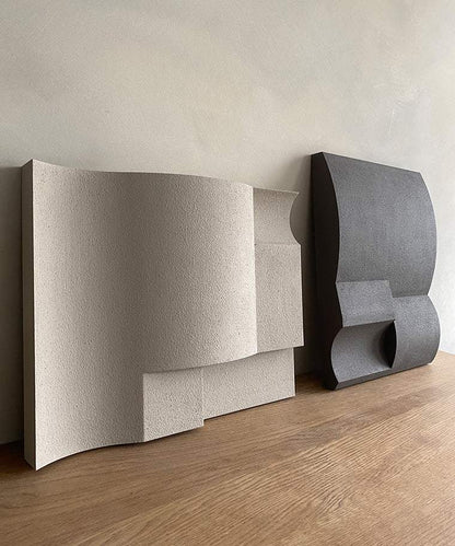 Hand-made art sculptures with sand texture and eco-paint finish on a wooden surface.