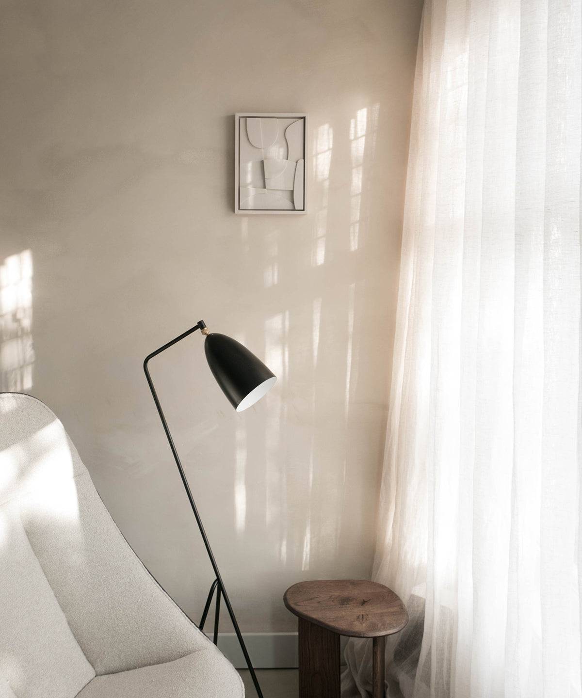 20.2 Archi wall art in modern living room setting with floor lamp and small table.