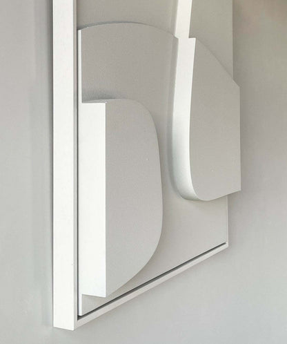 3D art piece with minimalist design in white, featuring geometric shapes on a framed base.