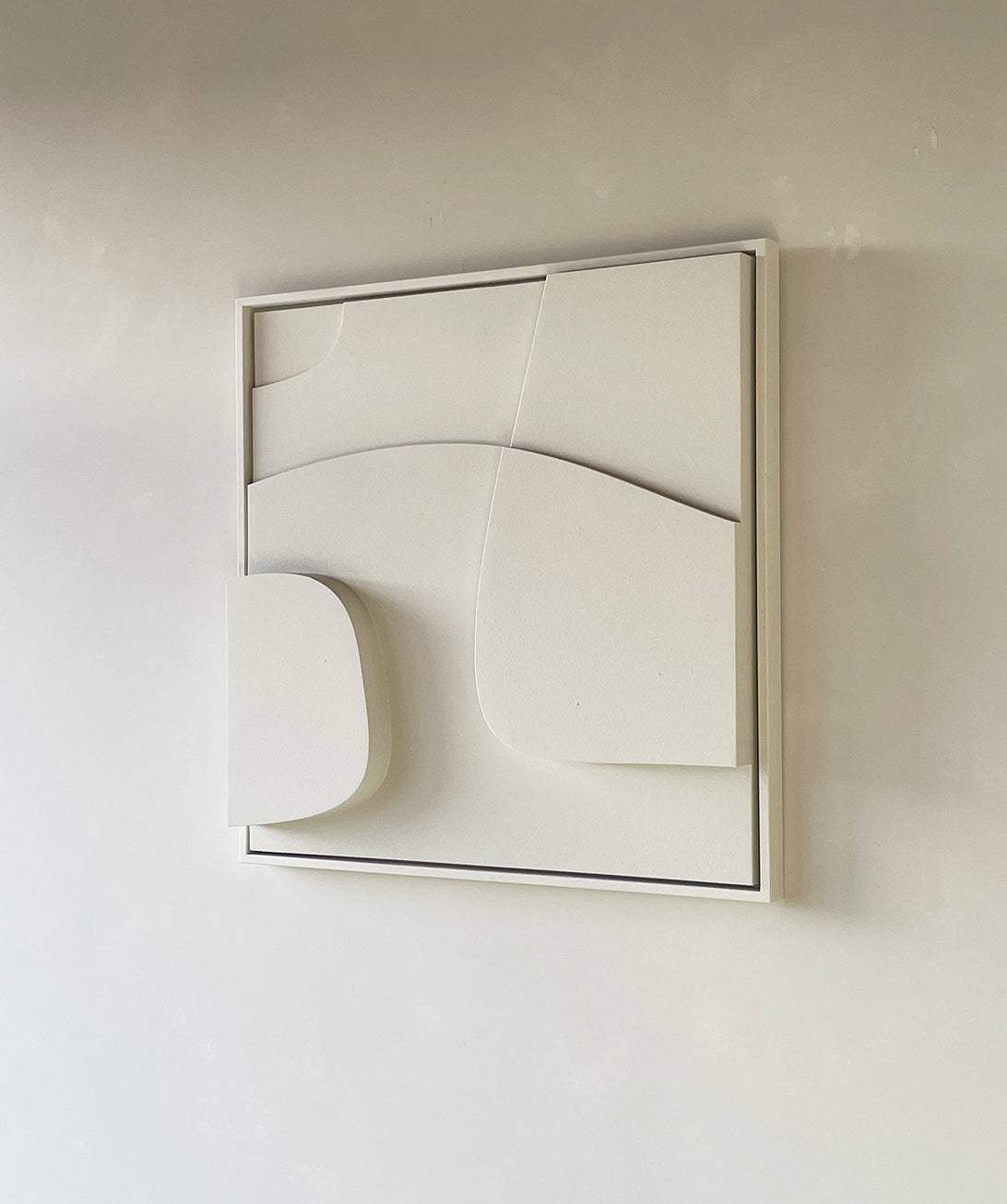 Handmade 3D art piece with sand texture finish in white frame.