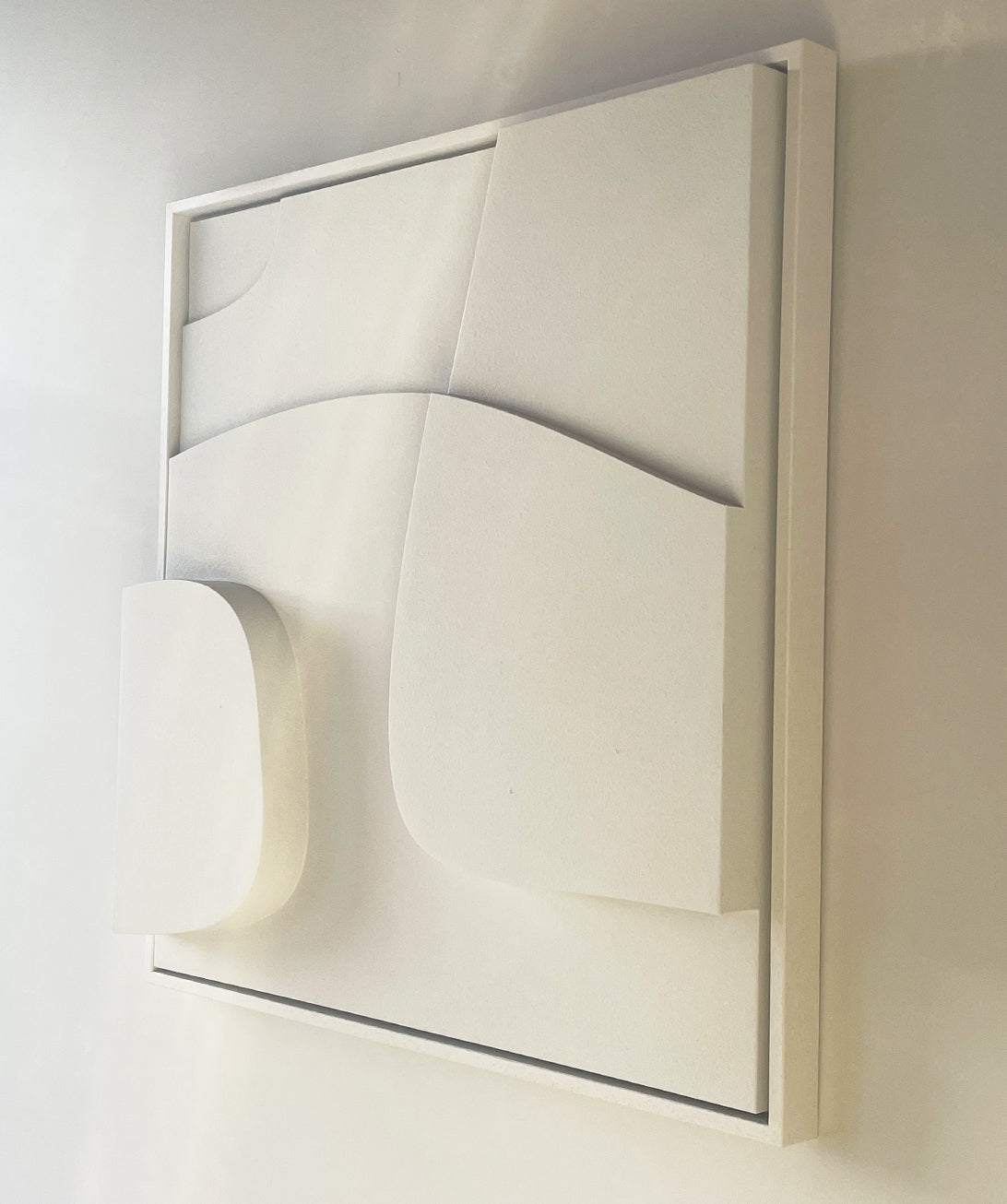 Handmade abstract wall art in white with sand texture and eco-paint.