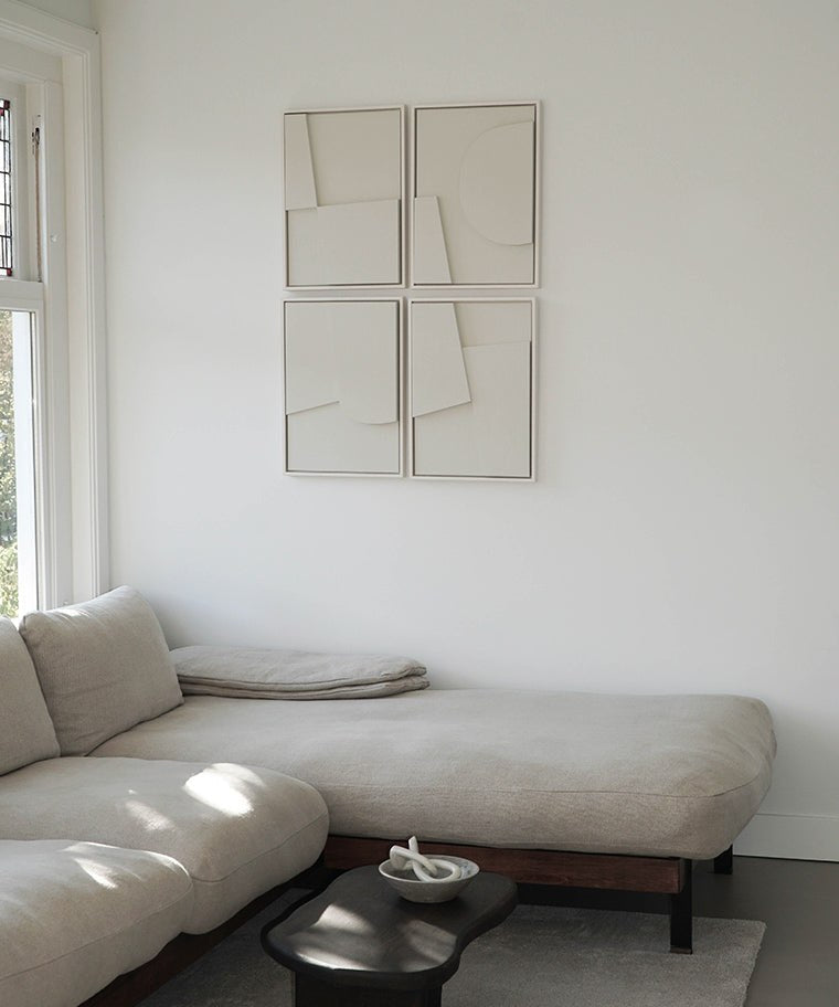 Hand-made art Quartet displayed on a white wall above a beige sofa in a bright living room.