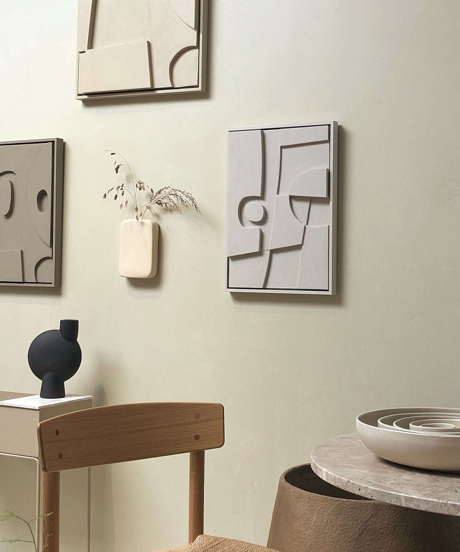 Handmade 20.8 Ebe art pieces on wall with minimalist decor.