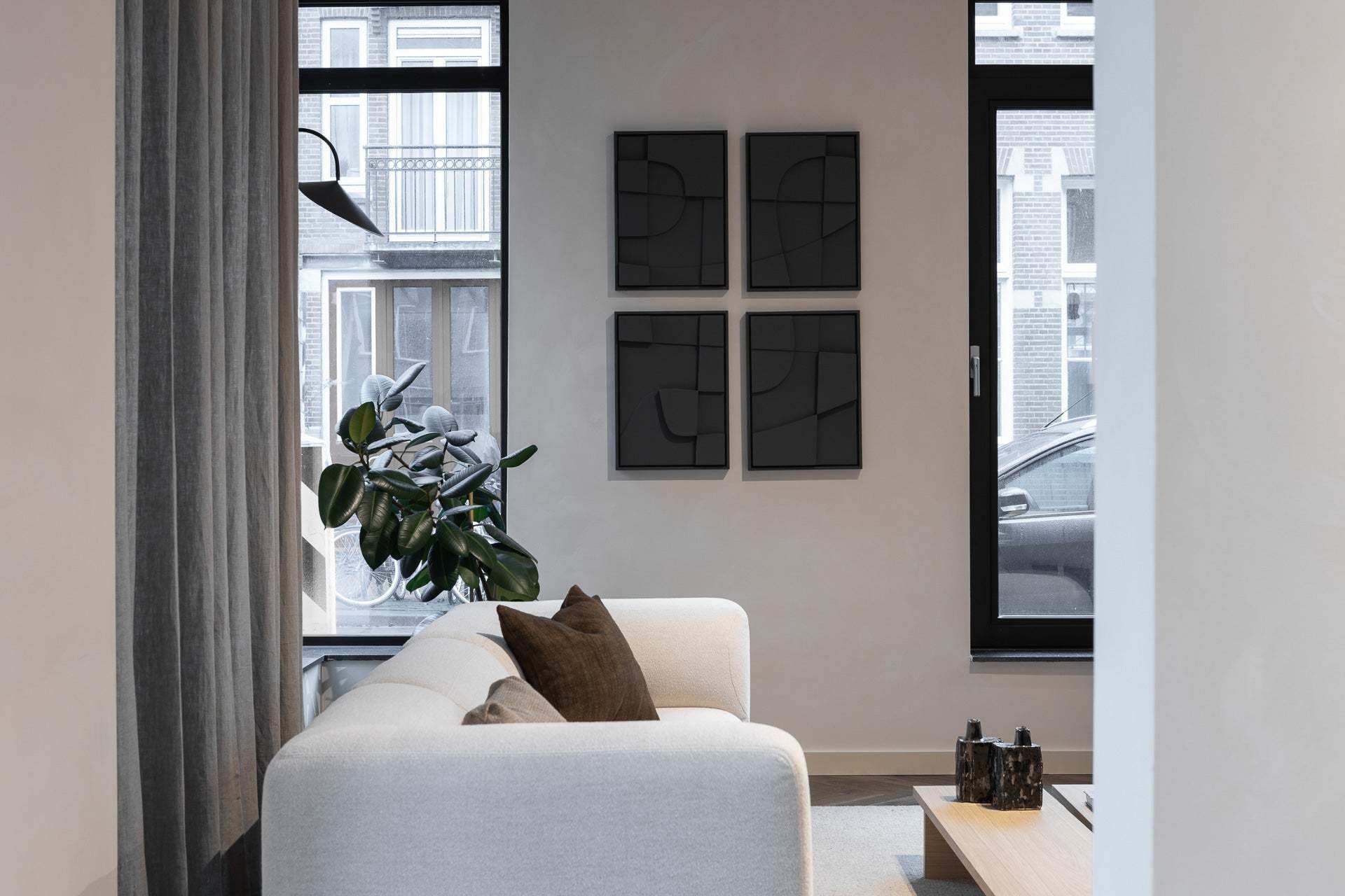 Quartet - Tête à Tête artwork in modern living room with white sofa and black geometric wall art.