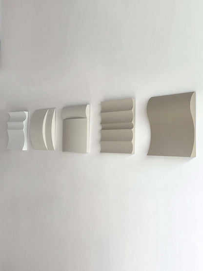 Contemporary wall art set in white, shadow white, dark lime, brown wood, and mud grey.