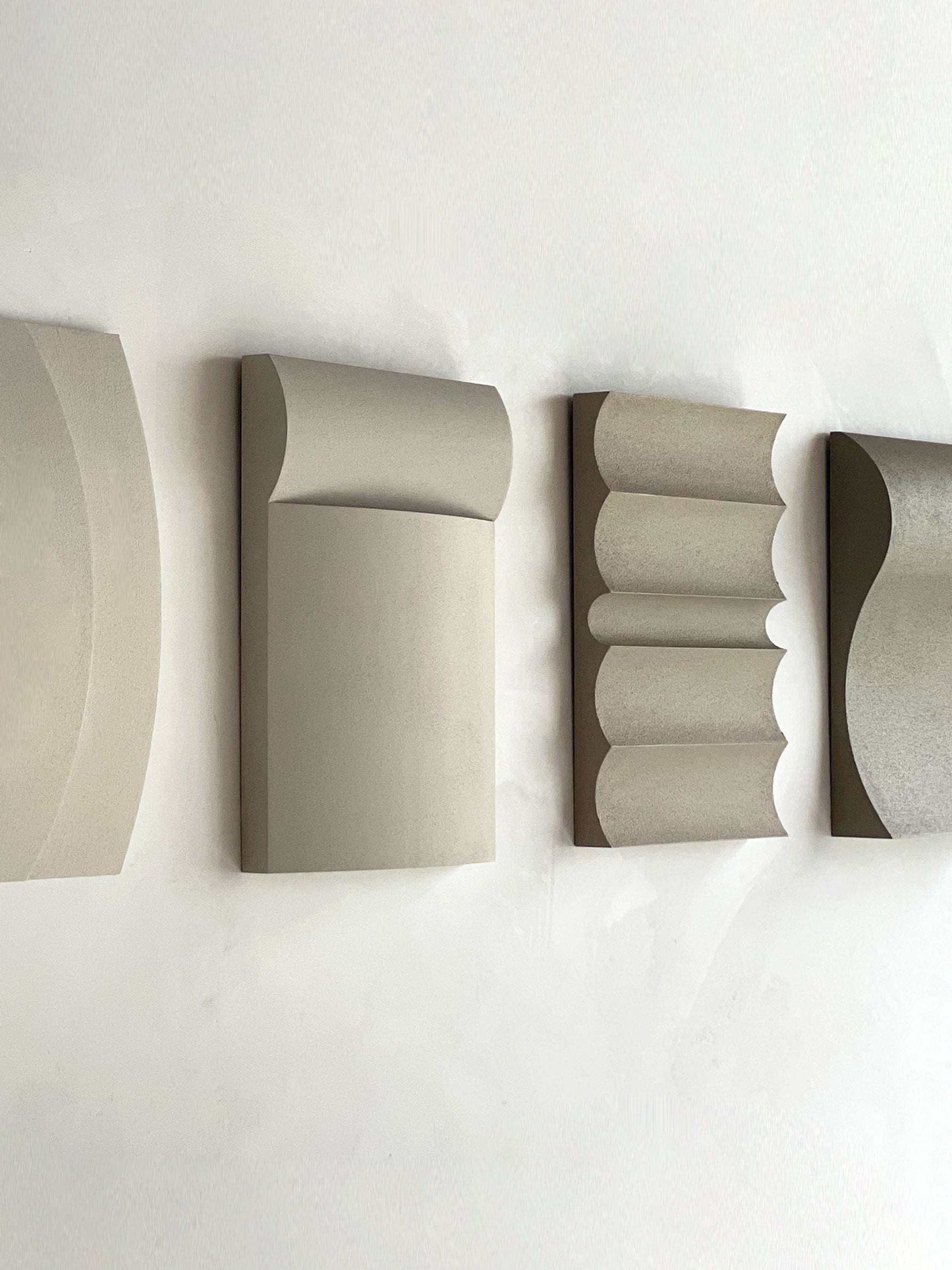 Contemporary wall art in white, shadow white, dark lime, brown wood, and mud grey finishes.