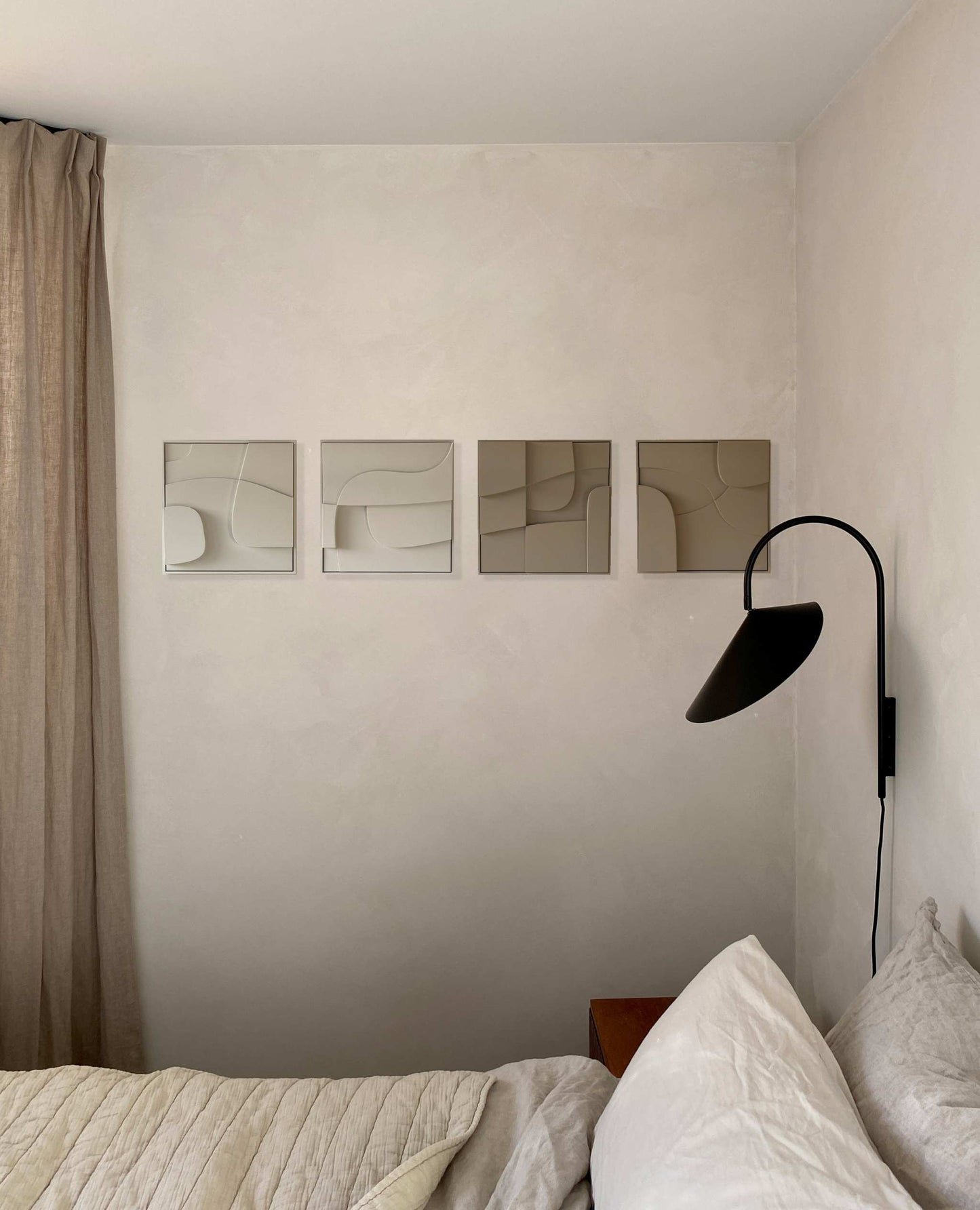 Hand-made 3D art pieces on a wall with minimalist decor.