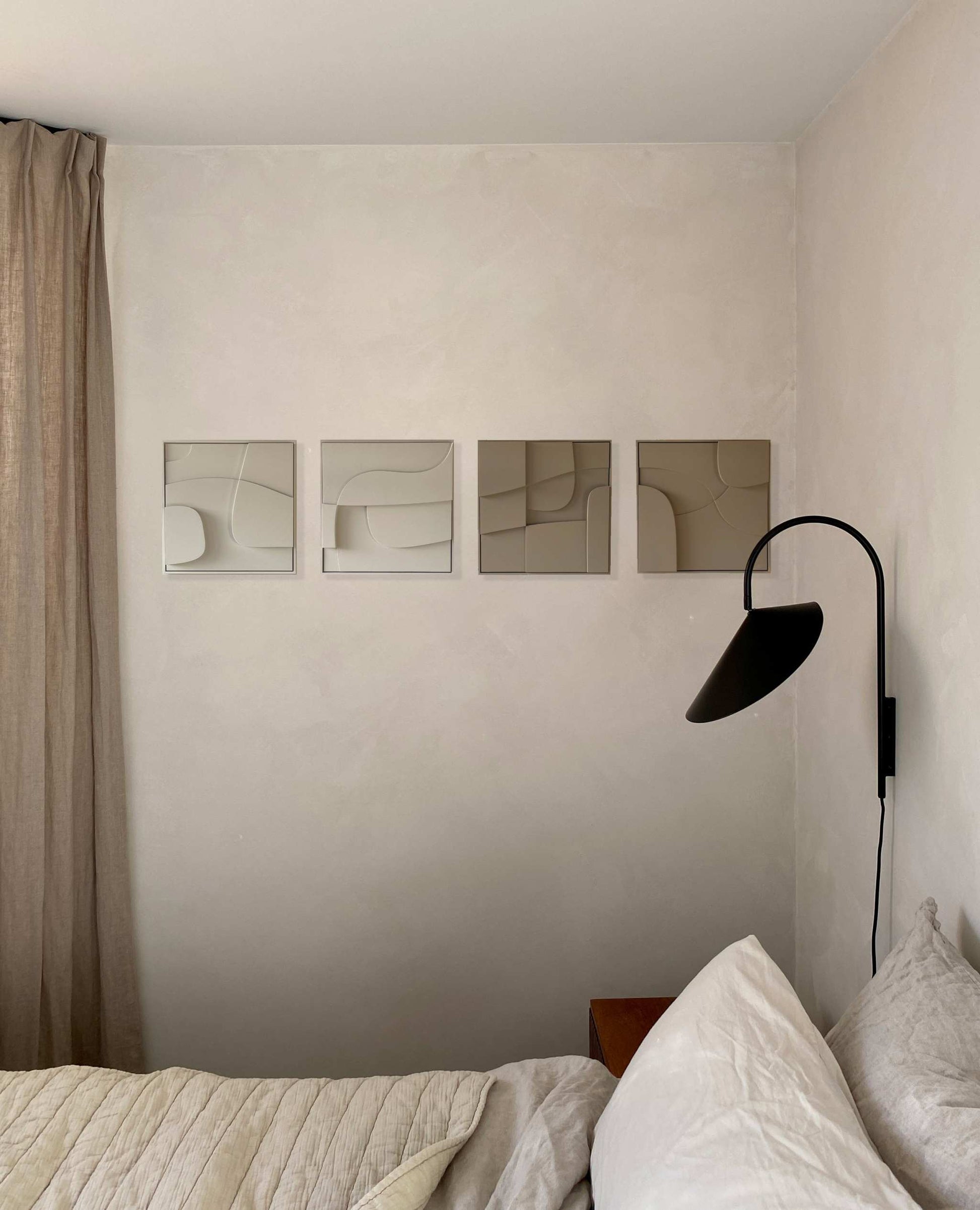 Hand-made 3D art pieces on a wall with minimalist decor.