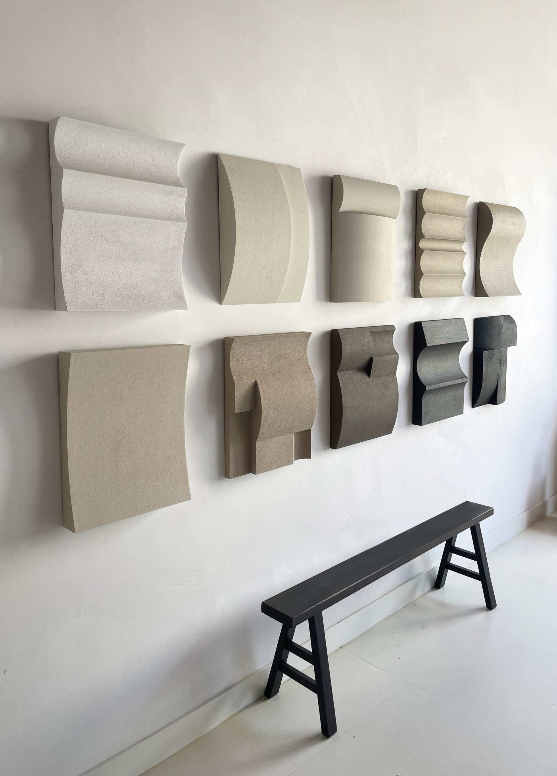 Set of 10 modern shapes in various colors on a wall display.