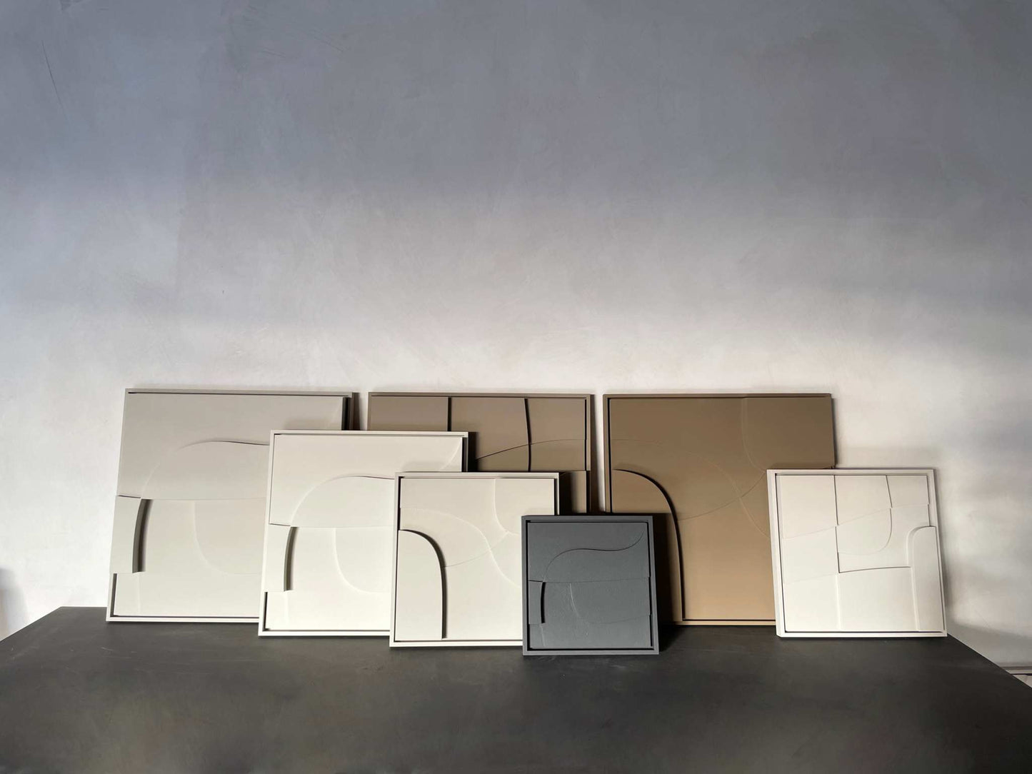 Hand-made 3D art pieces in neutral tones, crafted from plant-based PLA with sand texture and eco-paint finishes.